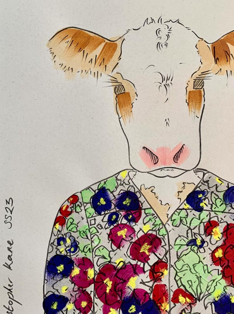 Details of a colourful illustration of a cow in designer Christopher clothing.