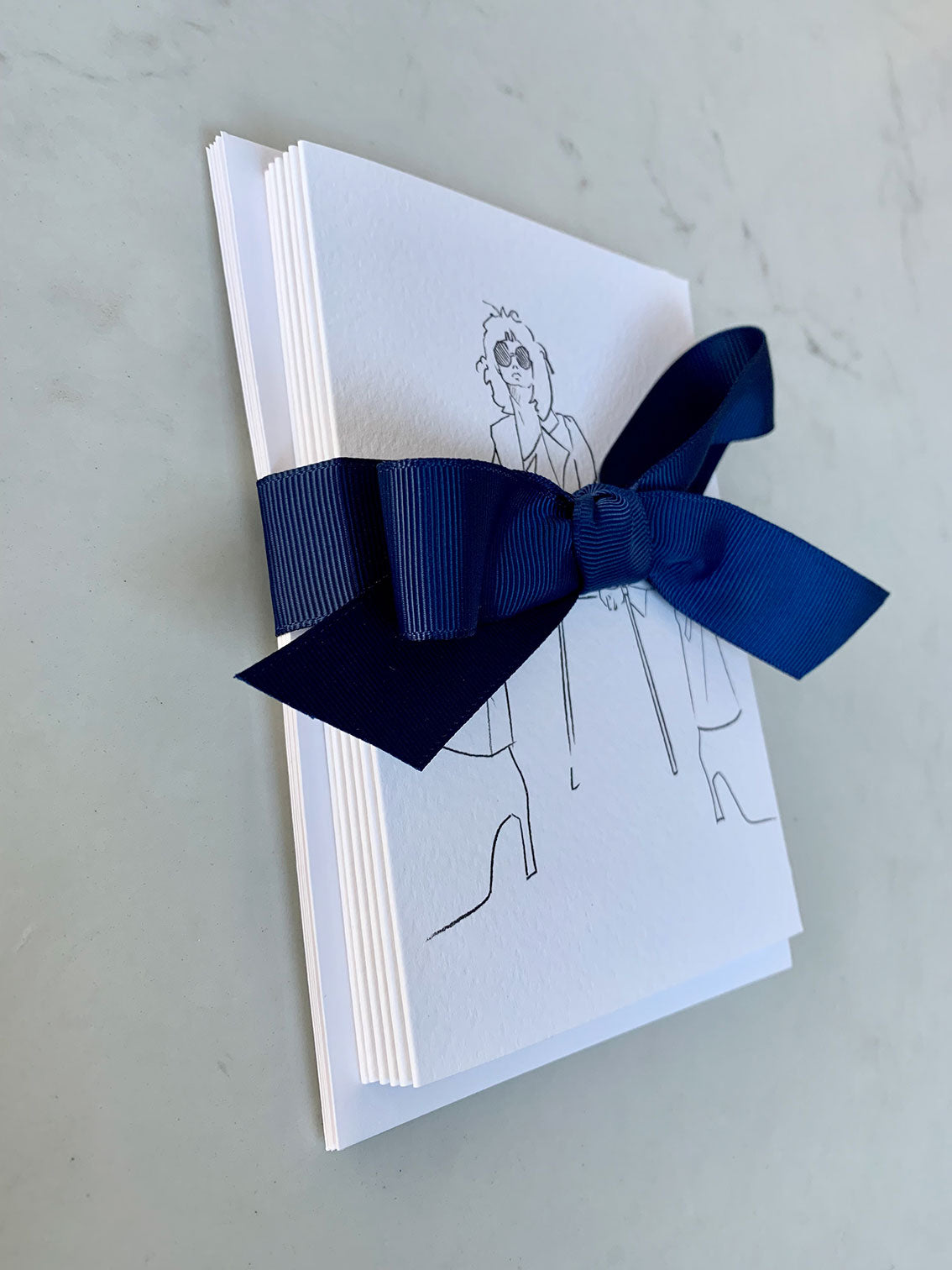 Set of 6 greeting cards with fashion illustrations wrapped in a navy ribbon.