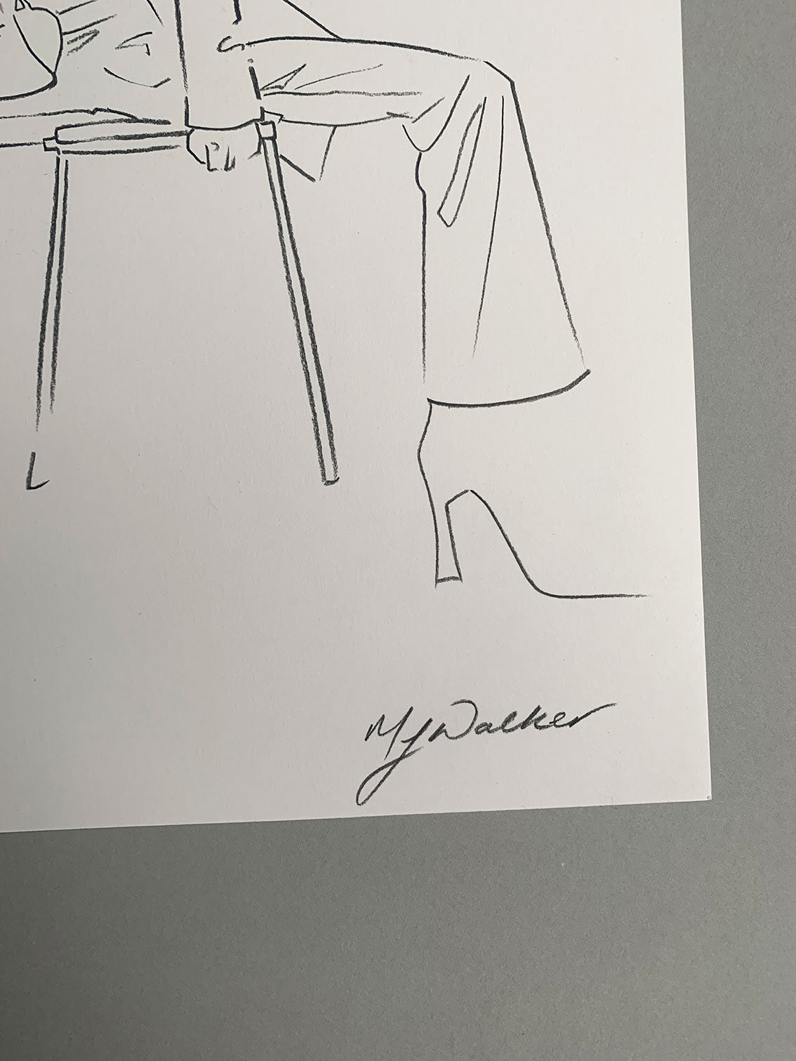Melanie Walker's signature on a fashion illustration of a lady sitting on a stool.